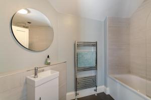 a bathroom with a sink and a tub and a mirror at 4 Bed in Masham oc-w32087 in Masham +30 photos