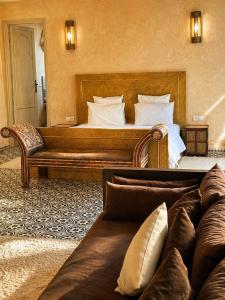 a hotel room with a bed and a couch at Riad Jawad & Spa in Marrakesh