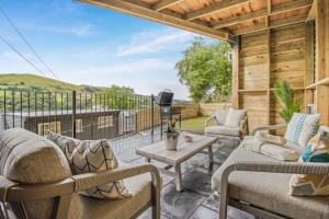 a patio with two couches and a table on a deck at 2 Bed in Cwmystwyth oc-p32779 in Pentre-briwnant