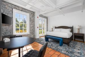 a bedroom with a bed and a table at Sonoma Stonehouse Hotel in Santa Rosa