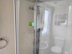a bathroom with a shower and a toilet at The Bay View in Eyemouth +17 photos