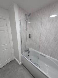 a bathroom with a shower and a bath tub at Highwood mews in Cleethorpes +8 photos