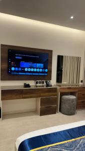 a hotel room with a large television and a bed at كلود فيو in Abha +14 photos