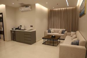a living room with a couch and a table at كلود فيو in Abha