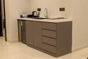 a kitchen with a sink and a stove at كلود فيو in Abha