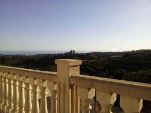 a white railing on a balcony with a view at Casa rural CAÑADA PAEZ in Vélez-Málaga