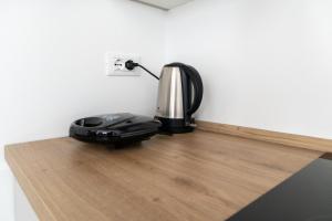 a coffee maker sitting on top of a wooden floor at Riviera Venice Apartments in Mira