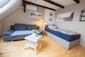 a living room with a bed and a couch at Pension Onken in Bockhorn