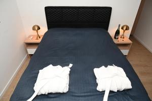 a bedroom with a bed with two white towels on it at Elysium3 in Banja Luka