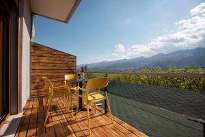 a table and chairs on a deck with a view at The Barrels Ms in Gjirokastër