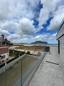 a balcony of a building with a view of the ocean at Lujosa casa en primera línea playa increibles vistas mar in Laredo