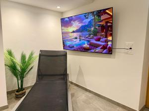 a flat screen tv hanging on a wall at Elevate in Ovronnaz