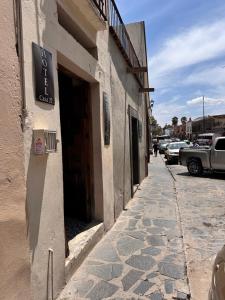 a building with a sign on the side of a street at Hotel Casa 22 in San Miguel de Allende
