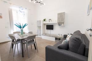 a living room with a couch and a table at La Casetta al mare in Balestrate