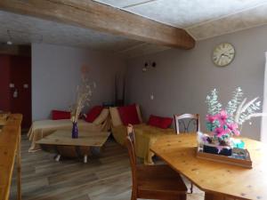 a living room with a couch and a table at Chambre bleue in La Roche-sur-Yon