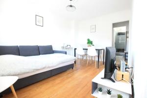 a living room with a bed and a tv at La Colline - Pont-Hébert - com - Grand Parking gratuit, De 1 à 4 personnes, Tout équipé, Netflix, Amazon Prime Gratuits et Illimités, Matelas Emma, Lave Linge, Vue sur la Vallée, RDC in Pont-Hébert +81 photos