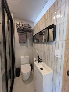 a small bathroom with a toilet and a sink at Rivulet Nook in West Hobart +12 photos