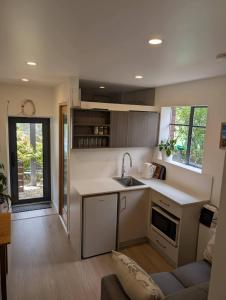 a kitchen with a sink and a couch in a room at Rivulet Nook in West Hobart