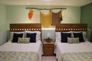 a bedroom with two beds and a lamp on a table at Casa La Vikina in Guanajuato