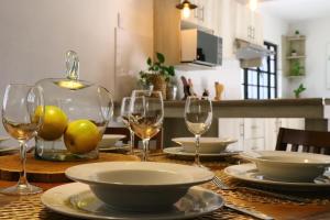 a table with wine glasses and plates on it at Casa La Vikina in Guanajuato +50 photos