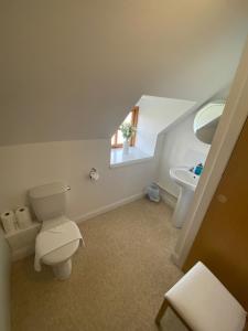 a bathroom with a toilet and a sink at Dolphin Bay Suites in Ardersier +43 photos