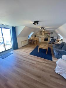 a living room with a couch and a table at Dolphin Bay Suites in Ardersier