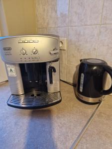 a coffee maker sitting on a counter next to a coffee pot at History Tornyos Apartman in Balatonfüred