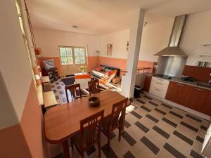 a kitchen and dining room with a table and chairs at Holiday house Mernye in Mernye