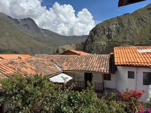 a group of buildings with mountains in the background at ollanta lodge in Ollantaytambo