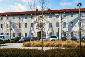 a large building with cars parked in a parking lot at SKYLINE MILANO Fiera in Milan