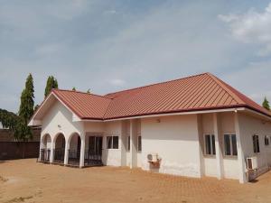 a large white house with a red roof at S & J Lodge with high speed Starlink WiFi in Tamale