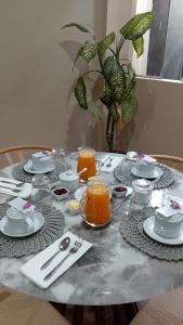a table with plates and cups and utensils on it at Altitud 620 Boutique Suites in Nazca +13 photos