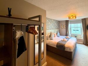 a hotel room with a bed and a window at The Queen's Head in Alnwick