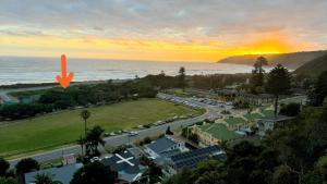 an aerial view of a city with the ocean at The Milkwood House in Wilderness
