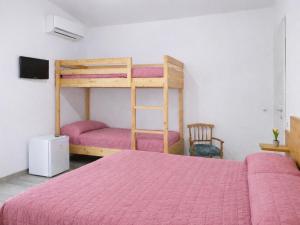 a bedroom with a bed and a bunk bed at Thalassa Holiday Home with Terrace near the Sea - Anzio in Anzio +23 photos