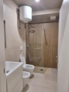 a bathroom with a toilet and a sink and a shower at Smarthome Boutique, Collegno in Collegno