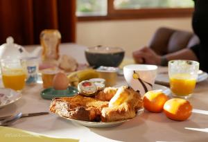 a table with a plate of breakfast food on it at Appart'Hotel-Restaurant Castel Emeraude in Amélie-les-Bains-Palalda