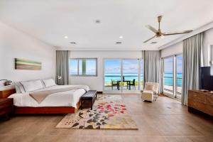 a bedroom with a bed and a view of the ocean at Skyline Villas - Villa Skyline with stunning Ocean View in Providenciales