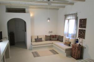 a living room with a couch and a window at Margarita Studio - Sunset View in Santorini +48 photos