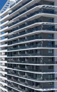 a large apartment building with balconies at Skyline Infinity Apartment Eagle Tower Benidorm in Benidorm