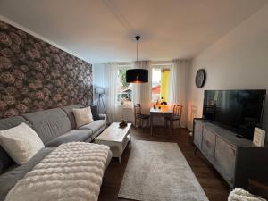 a living room with a couch and a flat screen tv at Herzstück in Schwanebeck +32 photos