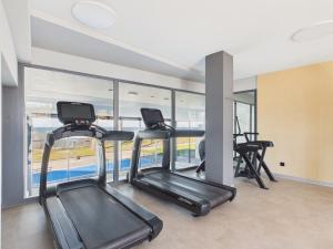 a gym with two treadmills and two exercise bikes at Baltic Horizon Klifowa by Solarento in Rewal