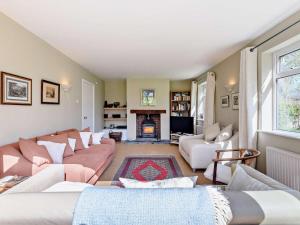 a living room with a couch and a fireplace at 4 Bed in Wareham oc-dc204 in East Stoke
