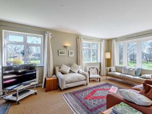 a living room with a couch and a tv at 4 Bed in Wareham oc-dc204 in East Stoke