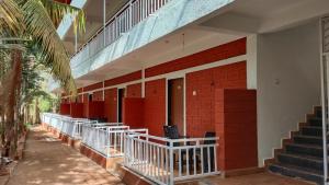 a red brick building with stairs and a balcony at Lotus Leaf Resort, Murud in Murūd