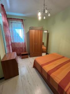 a bedroom with a bed and a dresser and a mirror at Bosco Dream Neptun-Olimp in Neptun +5 photos