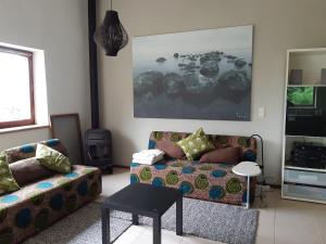 a living room with a couch and a table at Gîte de Thirifays in Chiny