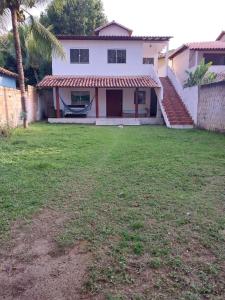 a house with a lawn in front of it at casa pescador centro in Porto Seguro