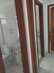 a bathroom with a toilet and a sink at casa pescador centro in Porto Seguro