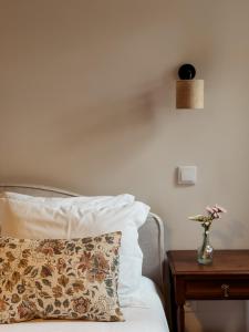 a bedroom with a bed with a pillow and a table at Casa do Caneiro in Vila Real